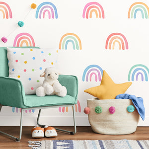 Children's room with rainbow pattern wallpaper, green chair, plush toy, and basket.