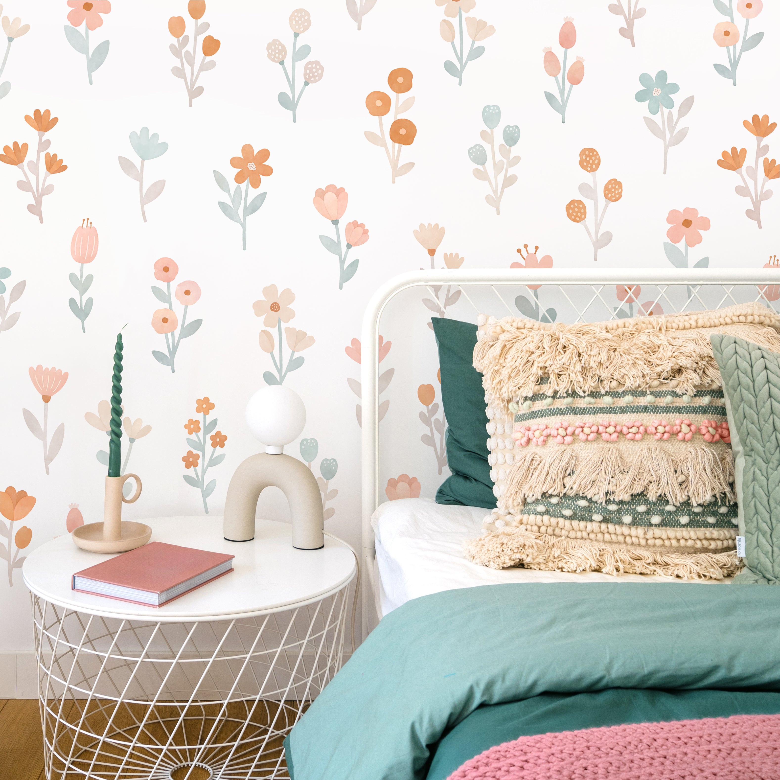 A floral wall decal in a nursery room setting with various colorful flowers and a cushion decoration.