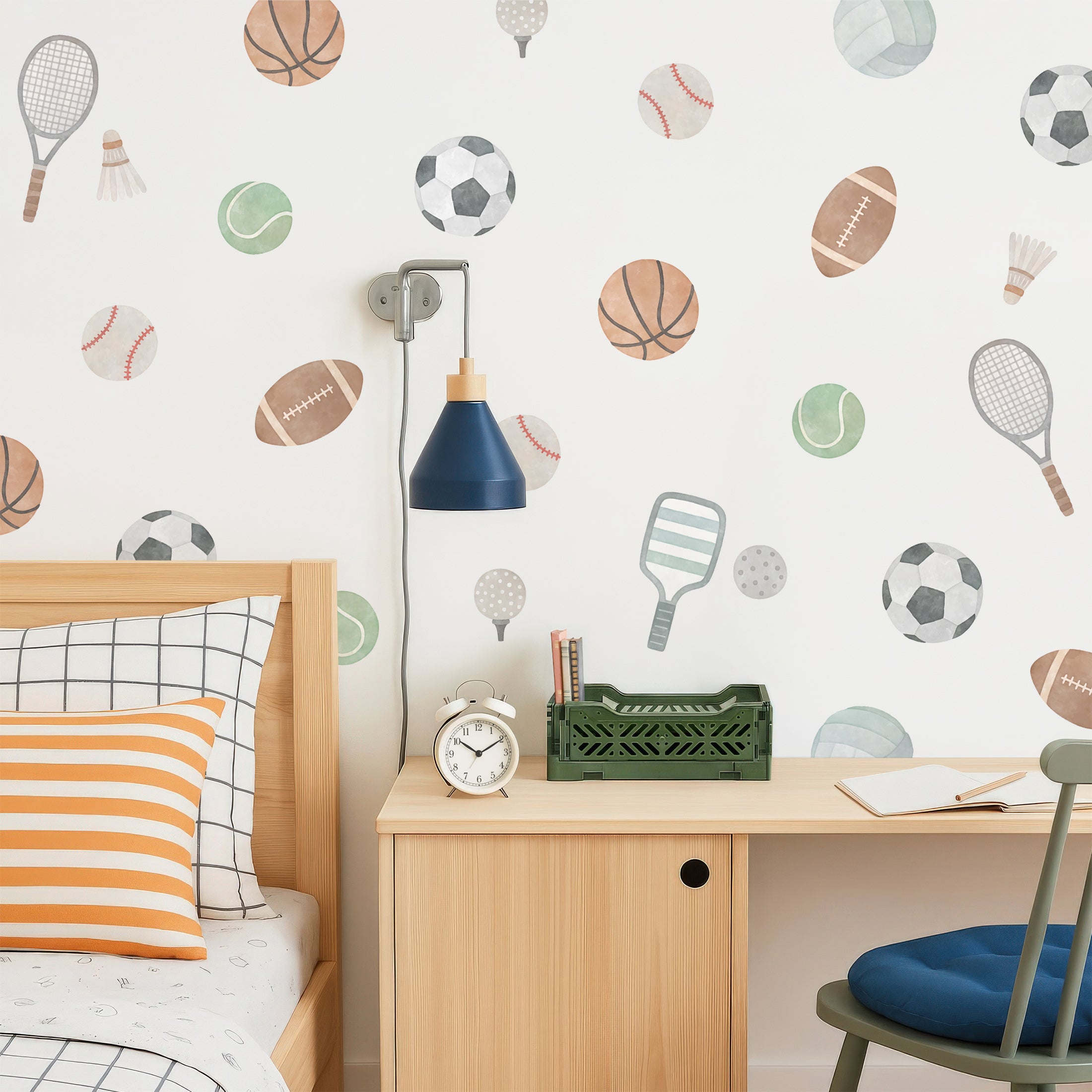 Sports-themed wall decals including basketball, soccer, and tennis decals on a wall in a room with a bed and a desk.